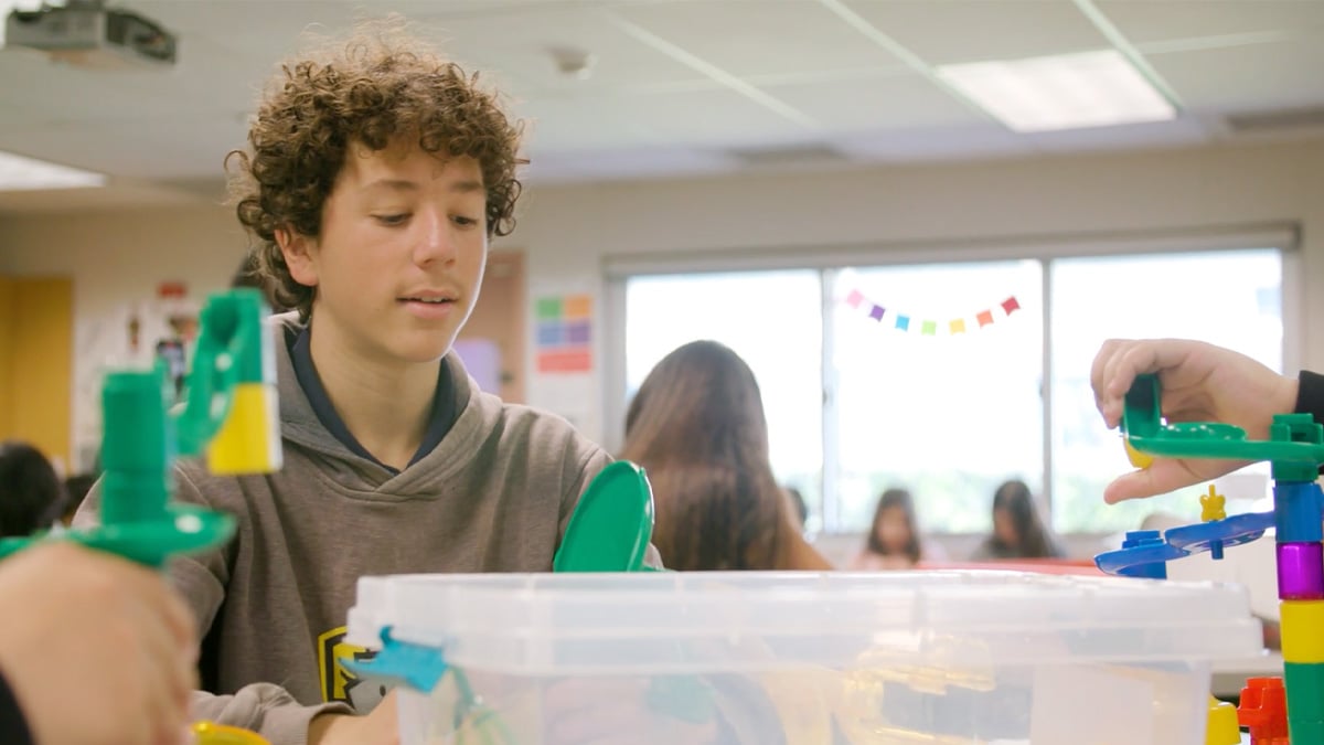 Students in transformed classroom after furniture giveaway